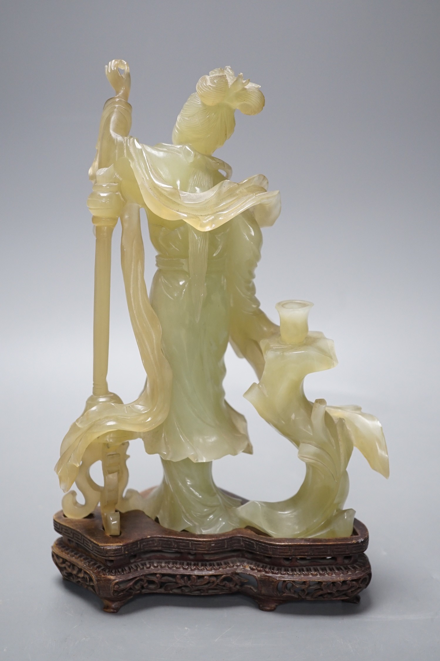 A Chinese carved bowenite jade figure of a lady on a hardwood stand 27cm